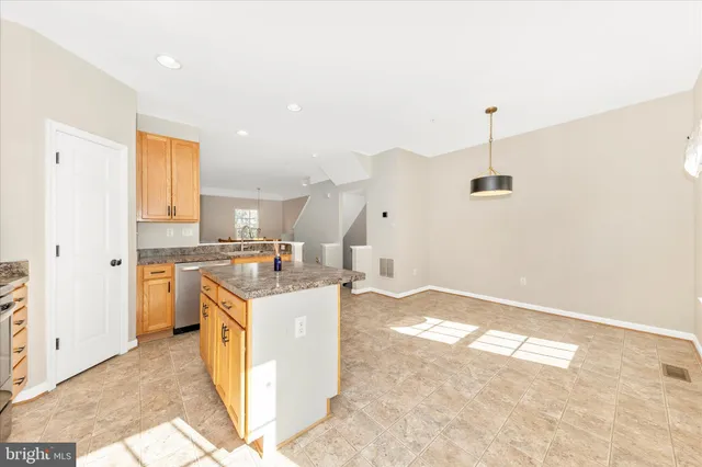 a open kitchen with stainless steel appliances granite countertop a sink stove and refrigerator
