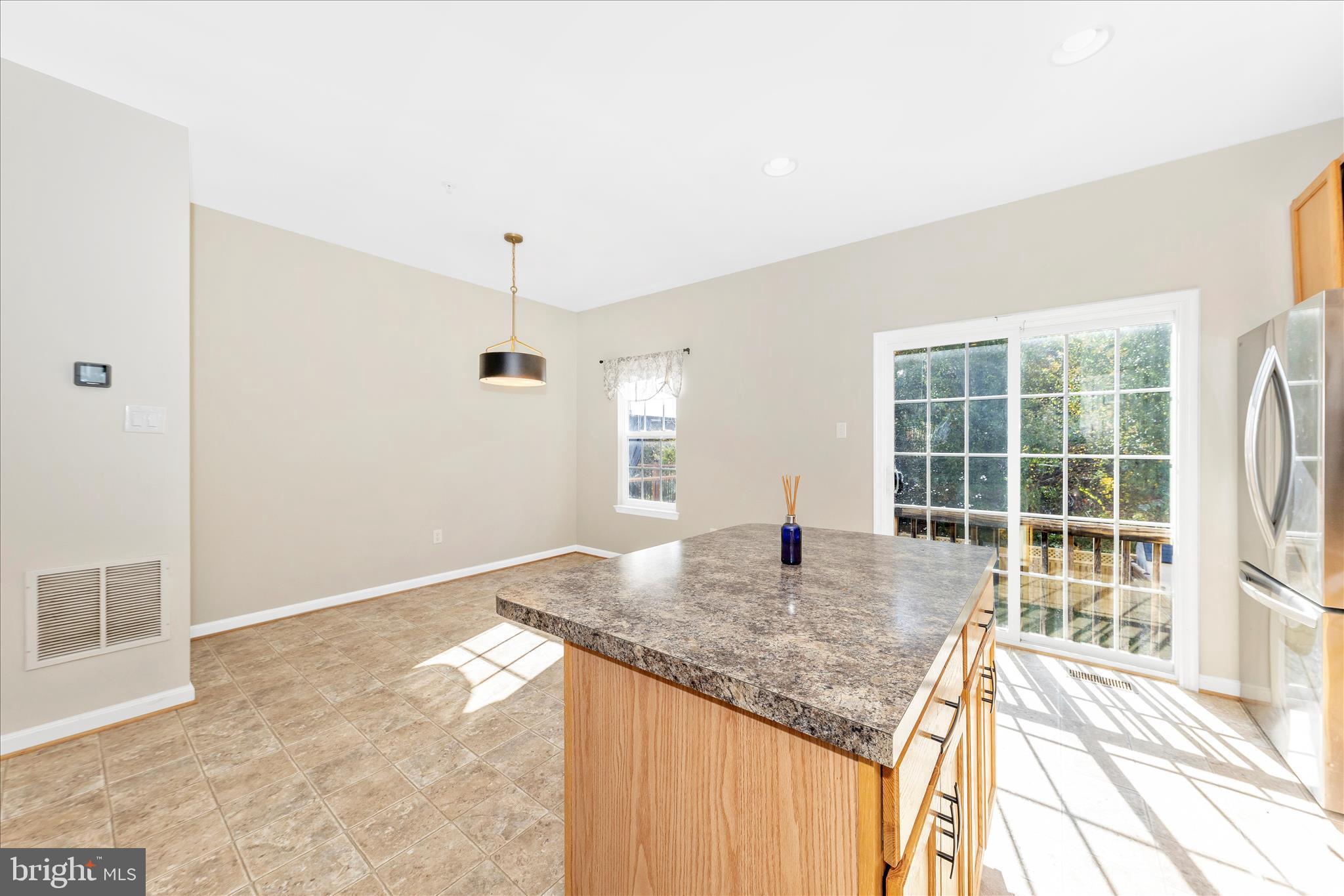 1812 Reading Court Mount Airy, MD 21771 - Photo 16 of 43 a kitchen with kitchen island granite countertop a stove and a granite counter tops with white walls