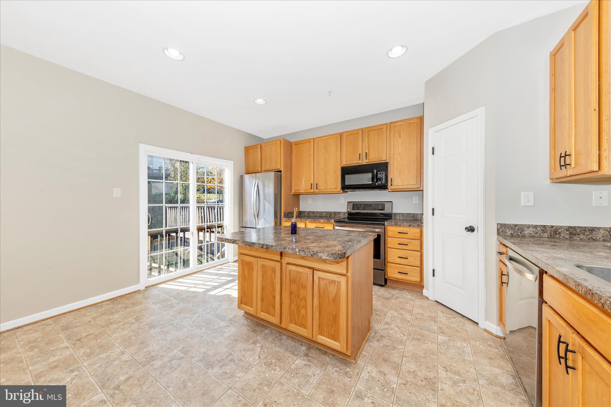 1812 Reading Court Mount Airy, MD 21771 - Photo 17 of 43 a kitchen with stainless steel appliances granite countertop a stove top oven a sink dishwasher a refrigerator and cabinets with wooden floor