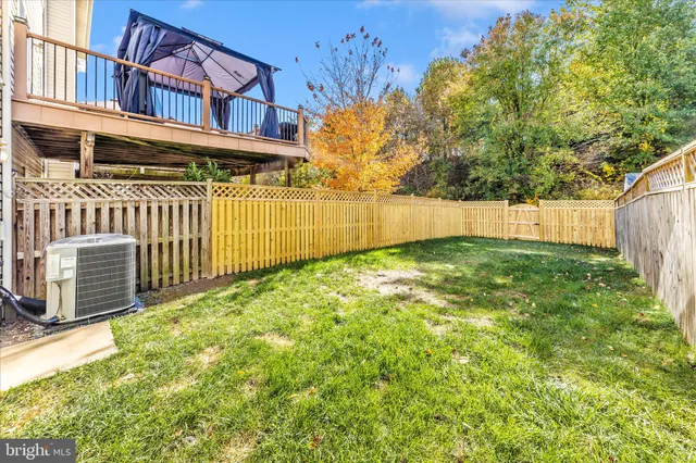 a view of a house with wooden fence