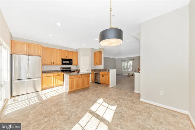 a kitchen with stainless steel appliances a stove a refrigerator and a sink