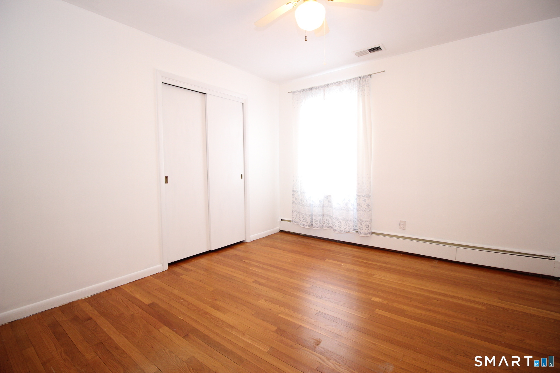 76 Elliott Road Trumbull, CT 06611 - Photo 12 of 26 a view of an empty room with wooden floor