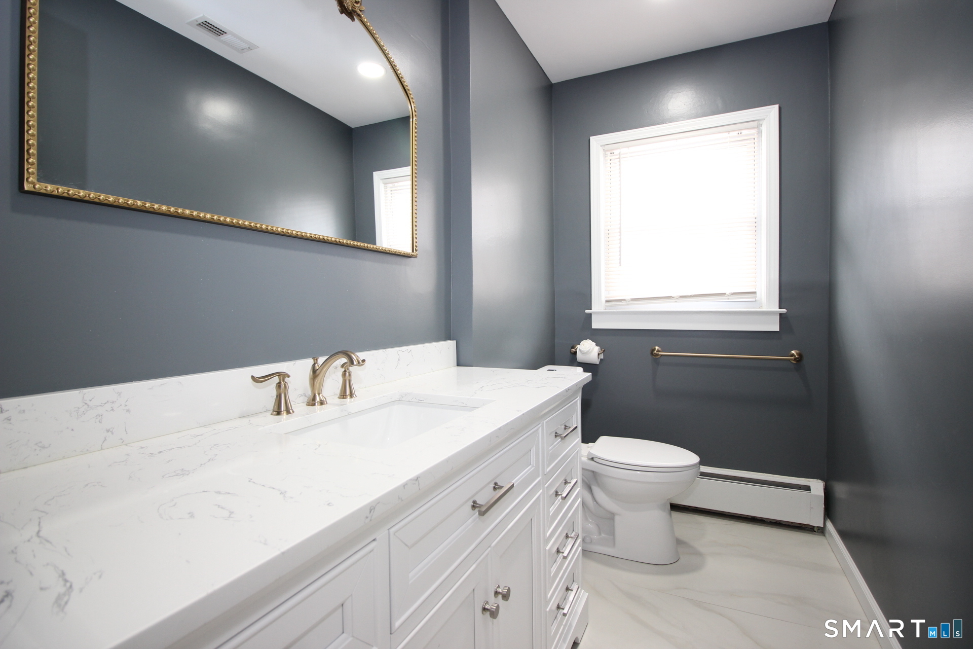 76 Elliott Road Trumbull, CT 06611 - Photo 16 of 26 a bathroom with a sink a toilet and a window