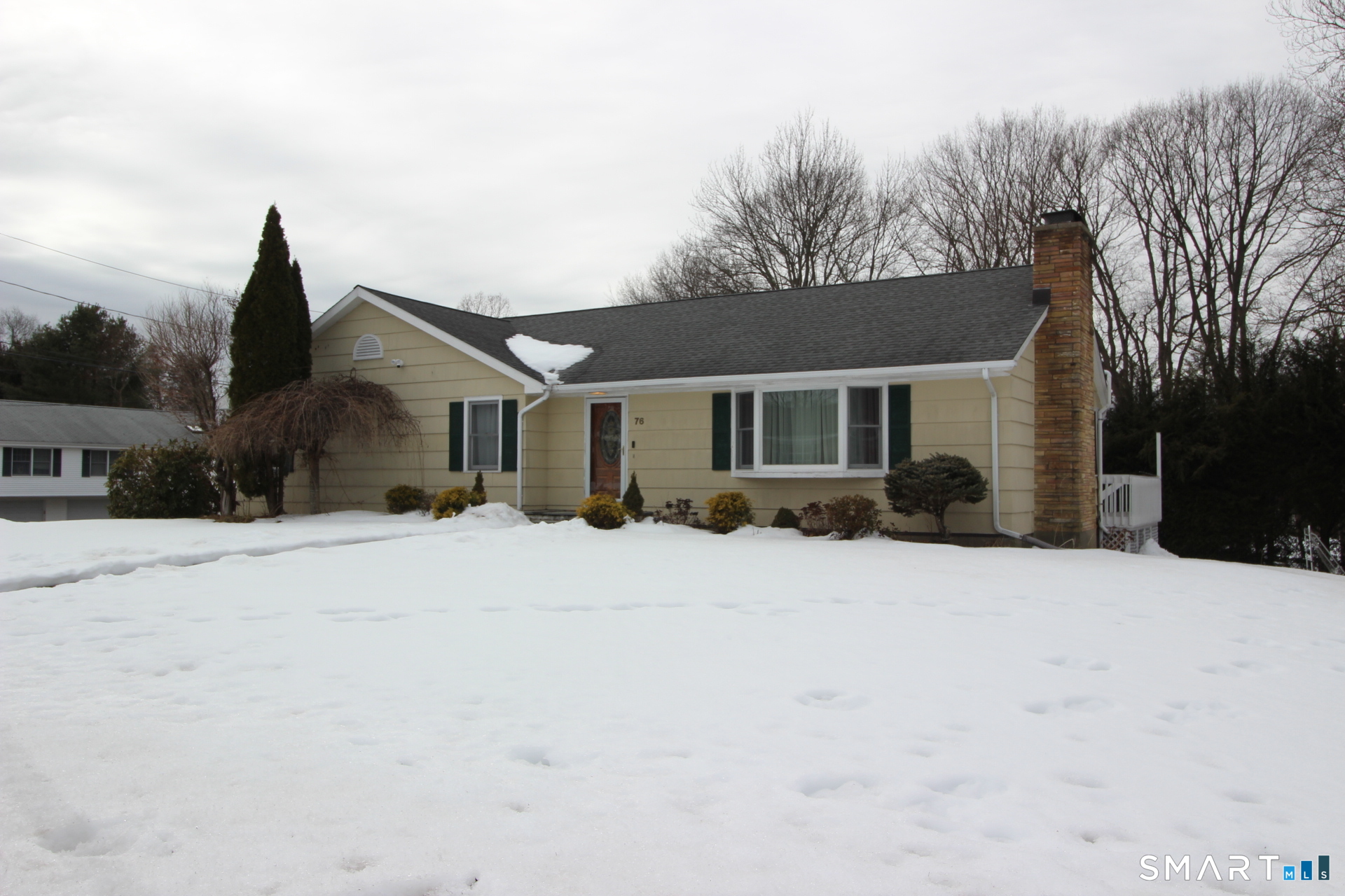 76 Elliott Road Trumbull, CT 06611 - Photo 2 of 26 a front view of a house with a yard and garage