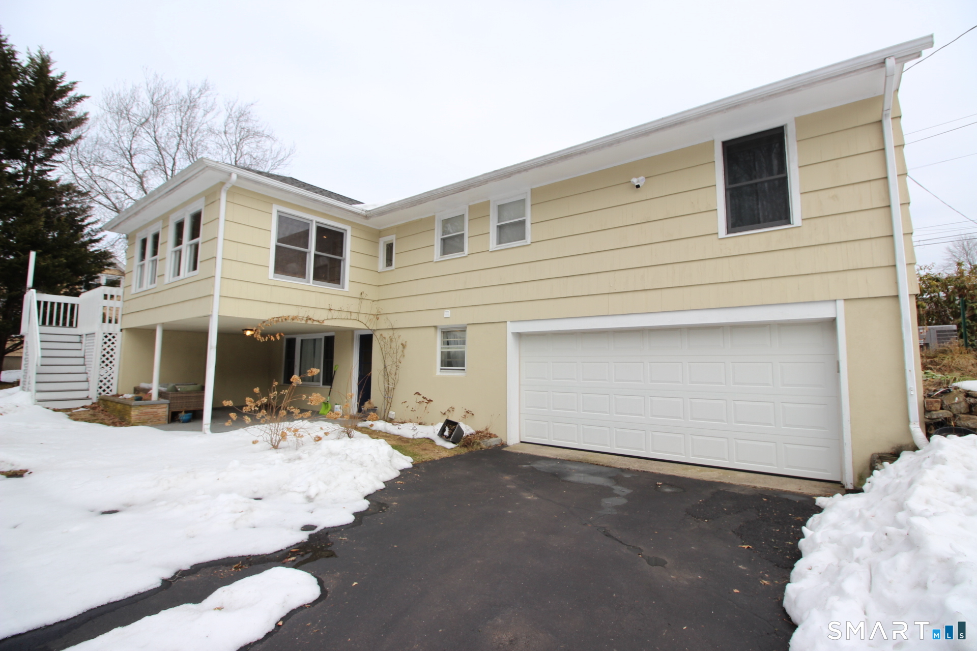 76 Elliott Road Trumbull, CT 06611 - Photo 24 of 26 a view of a house with snow on the road