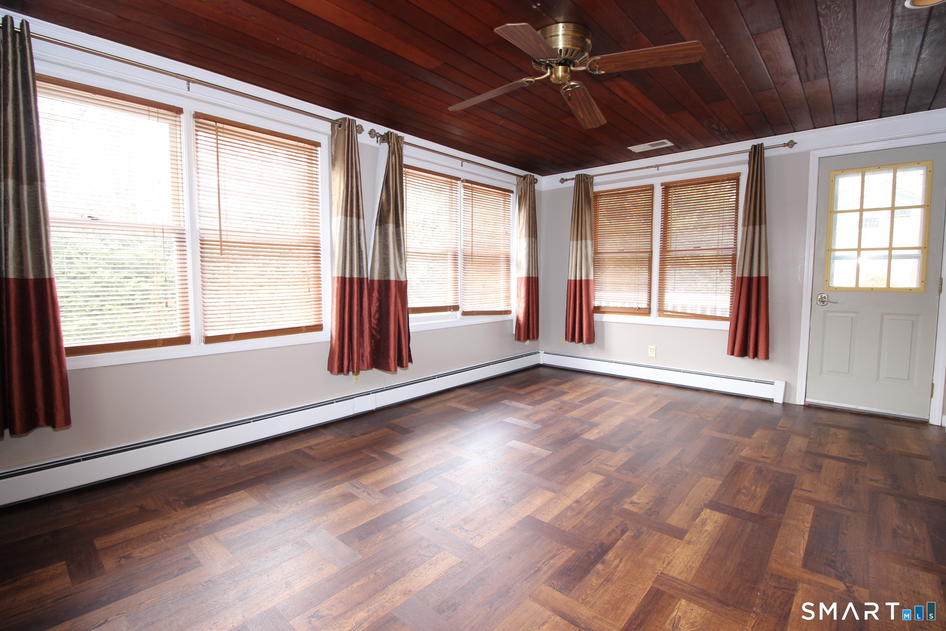 76 Elliott Road Trumbull, CT 06611 - Photo 9 of 26 a view of an empty room with a window and wooden floor