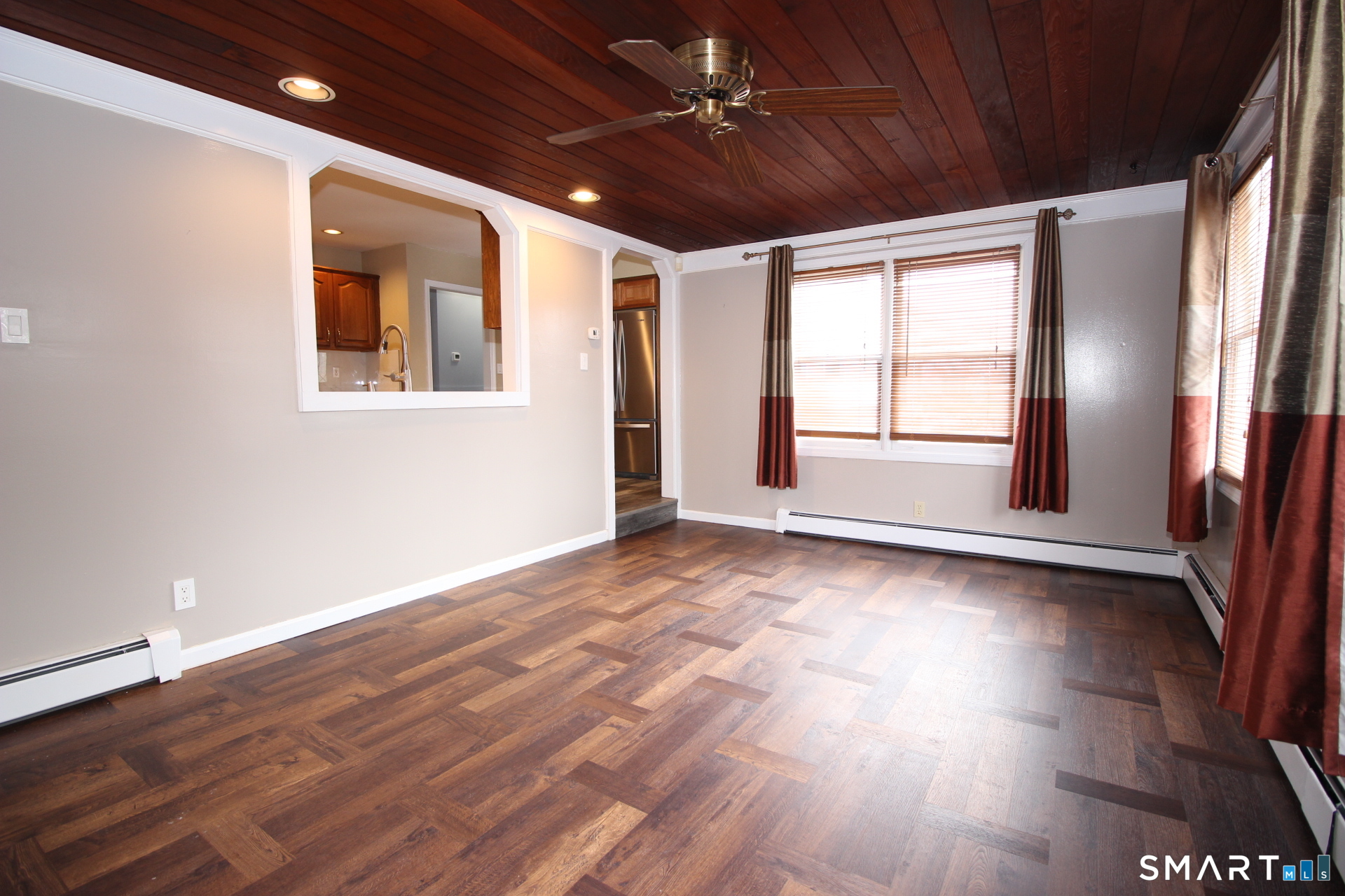 76 Elliott Road Trumbull, CT 06611 - Photo 10 of 26 a view of an empty room with wooden floor and a window