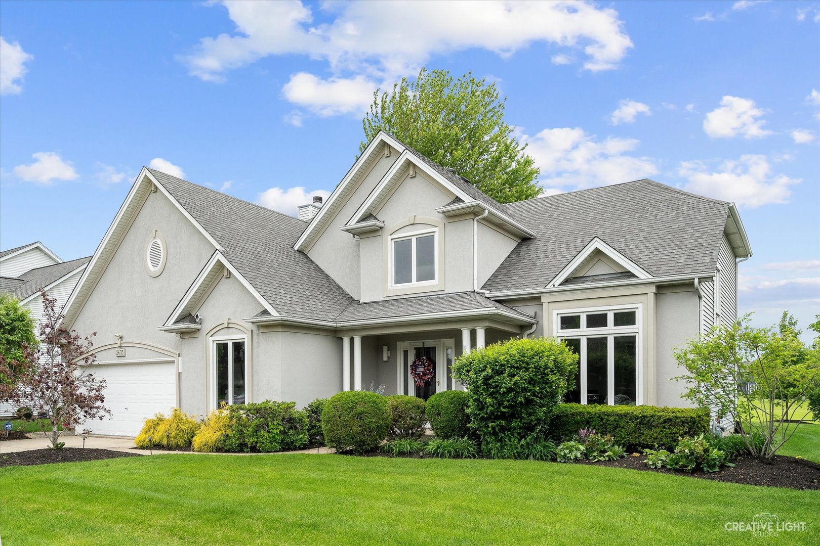 a front view of a house with a yard