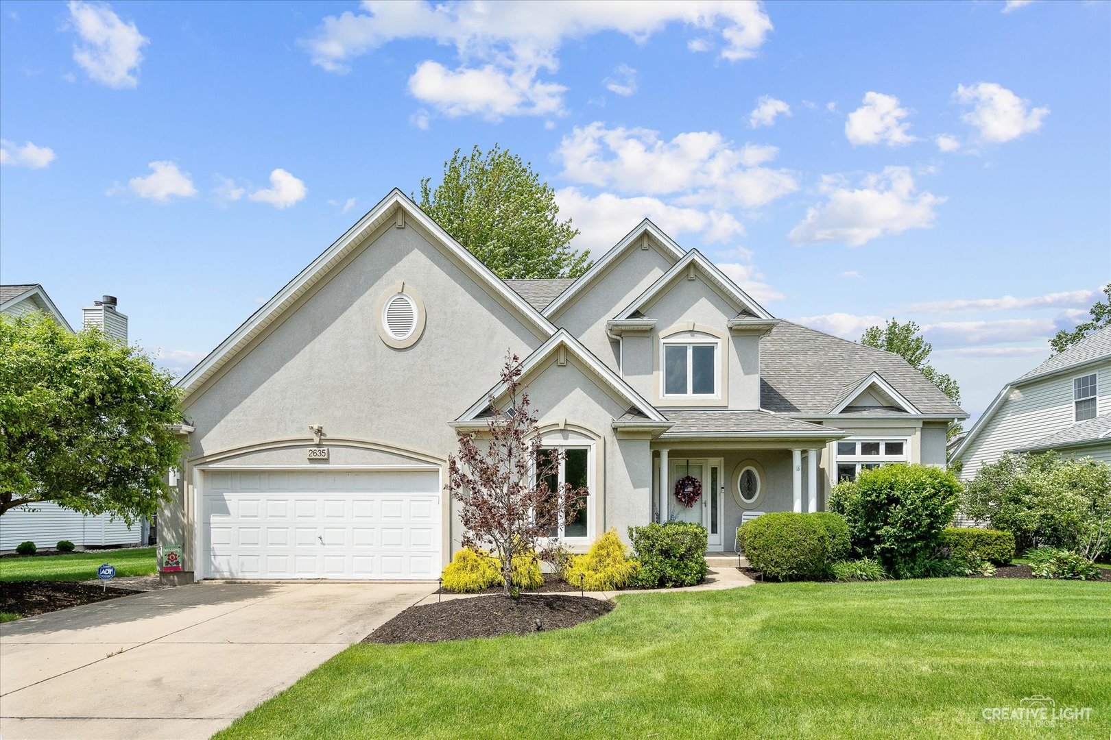 2635 High Meadow Road Naperville, IL 60564 - Photo 5 of 38 a front view of a house with a yard and garage