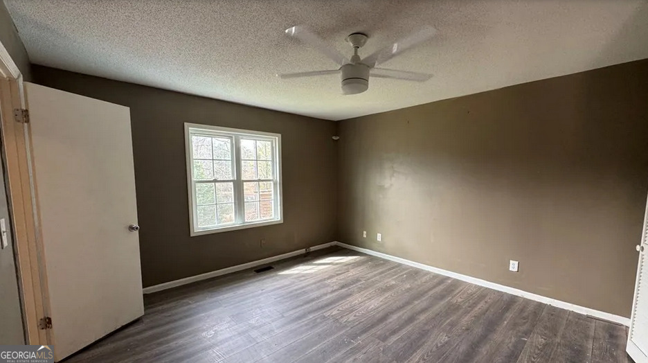 218 Hidden Springs Road Climax, GA 39834 - Photo 21 of 35 an empty room with wooden floor and windows
