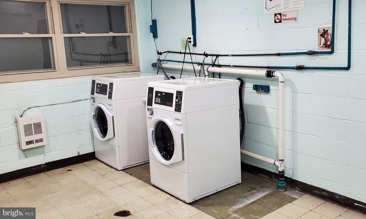 2305 Greenery Lane, Unit 1023 Silver Spring, MD 20906 - Photo 14 of 23 a utility room with dryer and washer