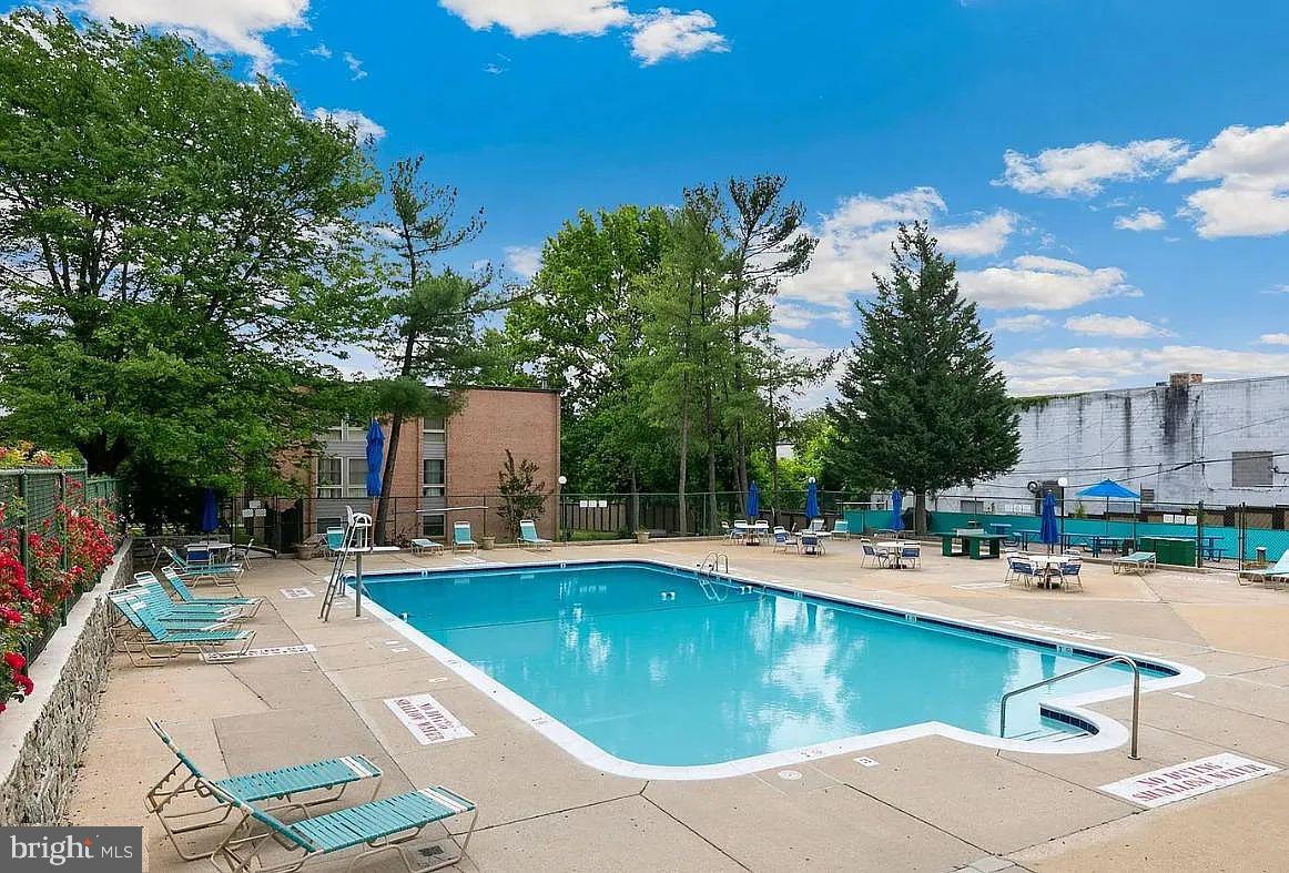 2305 Greenery Lane, Unit 1023 Silver Spring, MD 20906 - Photo 22 of 23 a view of a swimming pool with a patio