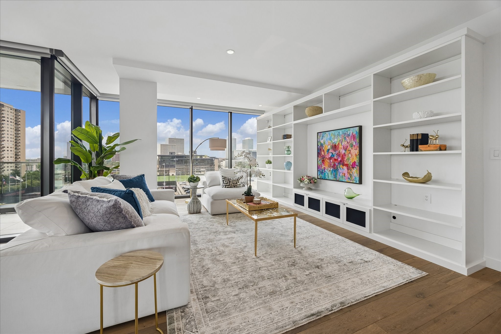 3433 Westheimer Road, Unit 702 Houston, TX 77027 - Photo 4 of 48 This modern living room features large floor-to-ceiling windows offering city views, sleek built-in shelving
