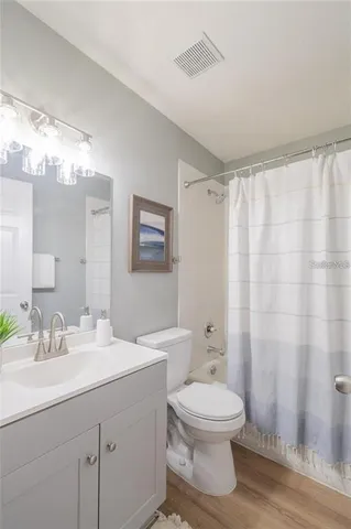 a bathroom with a toilet a sink and a mirror