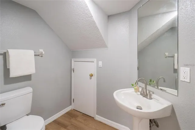 a bathroom with a sink toilet and a mirror