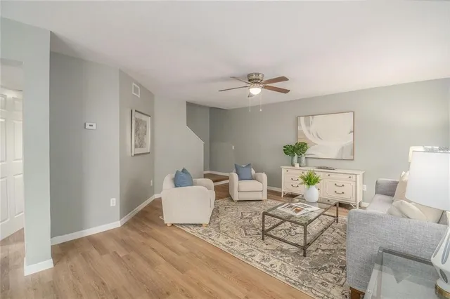 a living room with furniture and wooden floor
