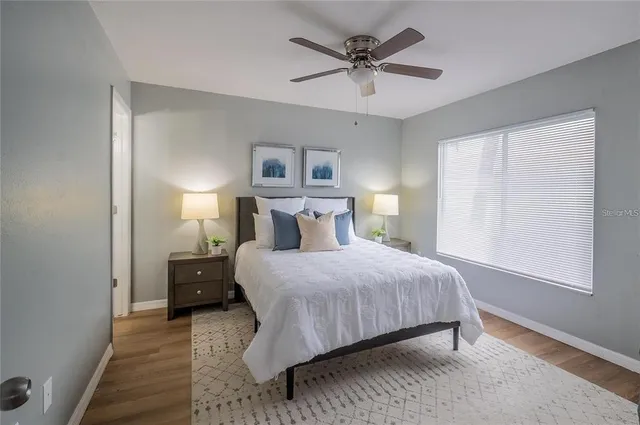 a bedroom with a bed and a window