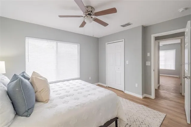 a bedroom with a bed and a chandelier