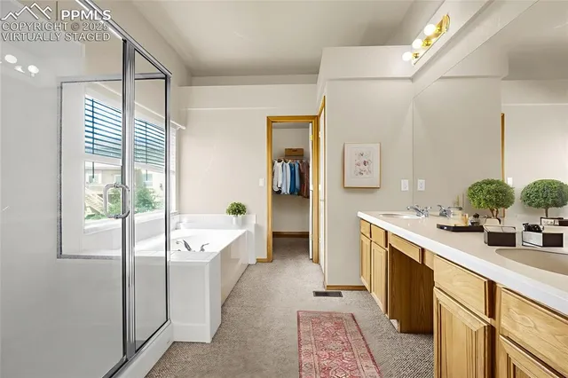 a spacious bathroom with a double vanity sink a mirror and a bathtub