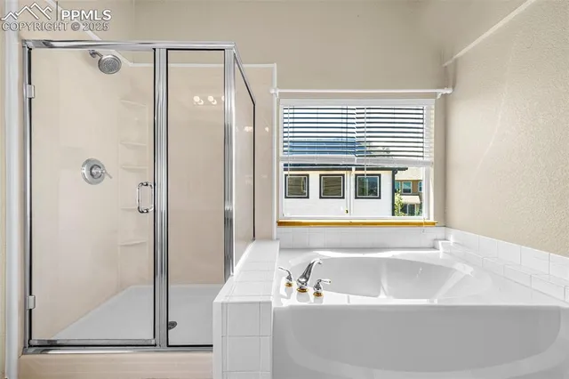 a bathroom with a bathtub and a shower
