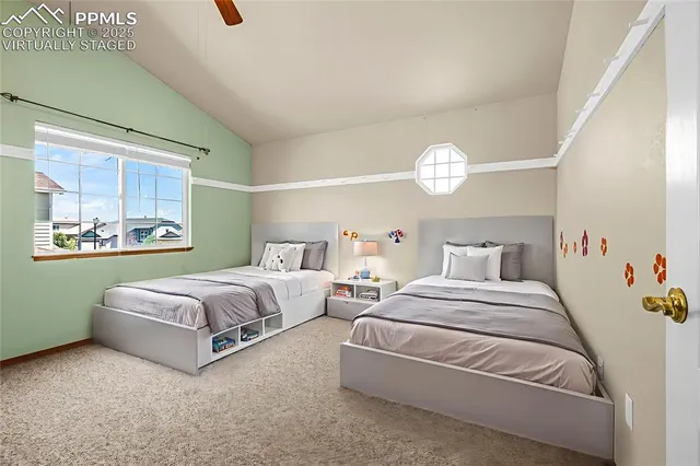 a bedroom with two beds and a window