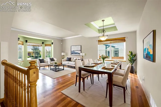 a view of a dining room with furniture window and wooden floor