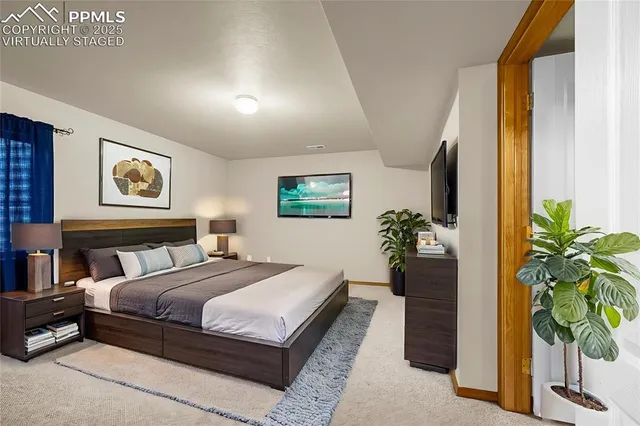 a bedroom with a bed table and a potted plant