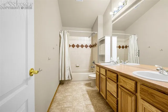 a bathroom with a granite countertop sink a toilet and a mirror