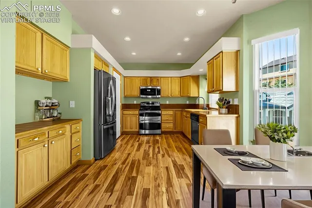 a kitchen with stainless steel appliances granite countertop a refrigerator and stove top oven