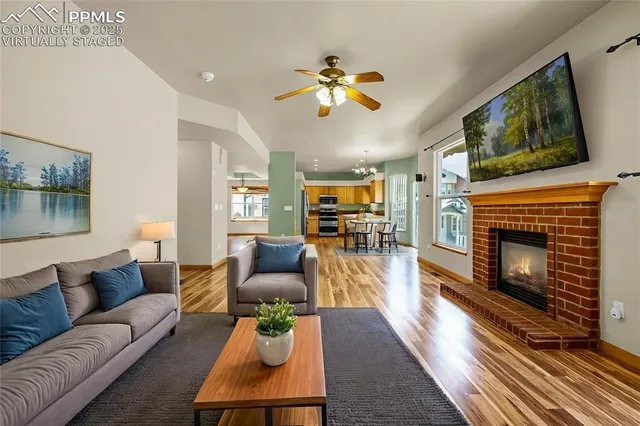 a living room with furniture a flat screen tv and a fireplace
