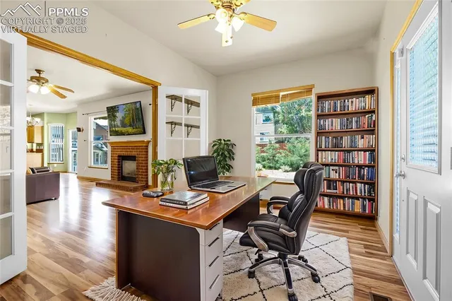 a view of a workspace with furniture and a window