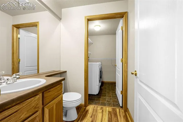 a bathroom with a granite countertop toilet sink and a mirror