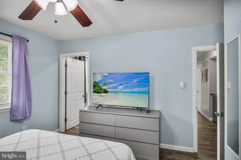 a room with a bed and a flat screen tv