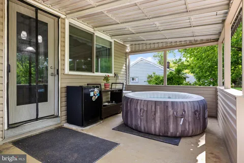 a view of a porch with furniture and floor to ceiling window