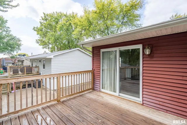 a view of a house with wooden deck