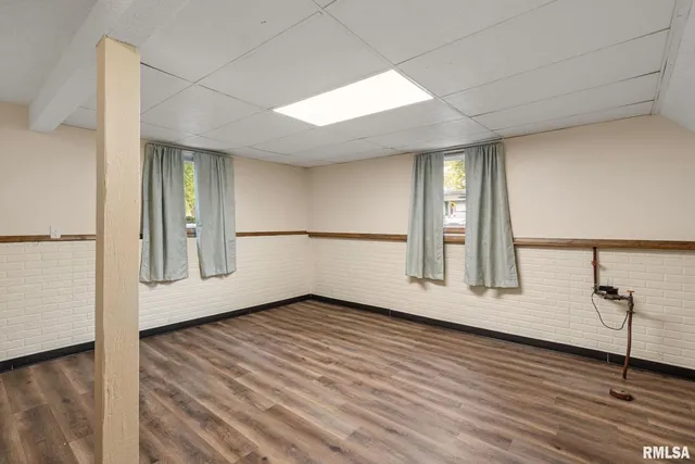 a view of a hallway with wooden walls