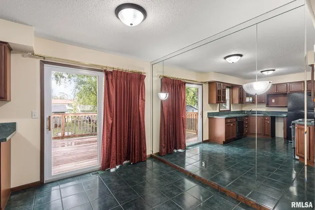 a open kitchen with stainless steel appliances granite countertop a refrigerator and a sink