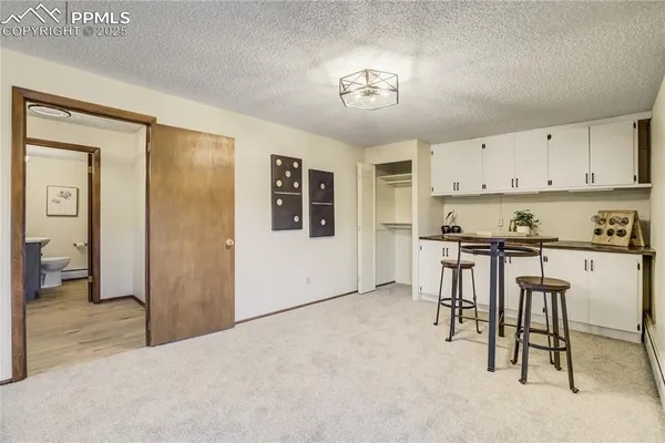 a view of kitchen with furniture and refrigerator