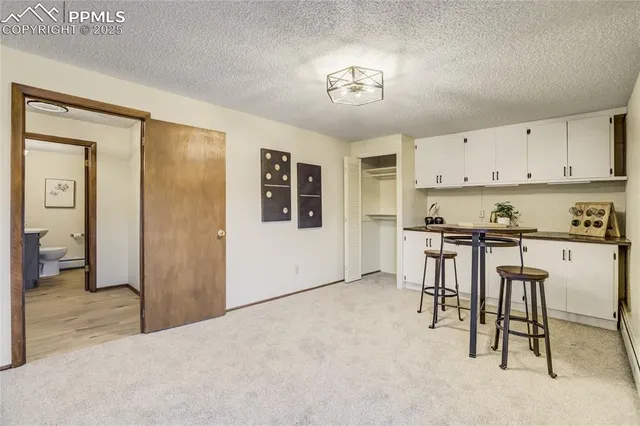 a view of kitchen with furniture and refrigerator