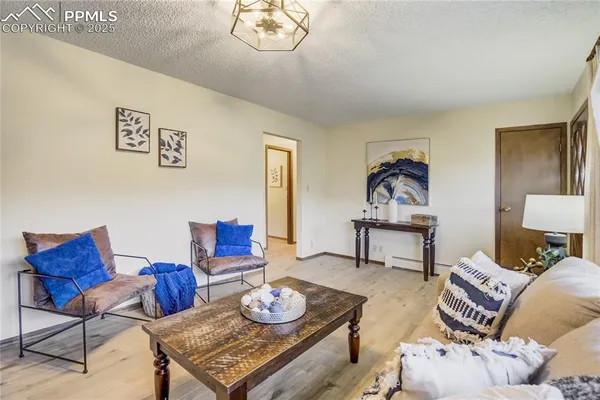 a living room with furniture and wooden floor