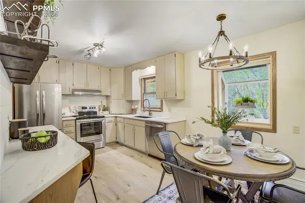 a kitchen with a table chairs stove and cabinets