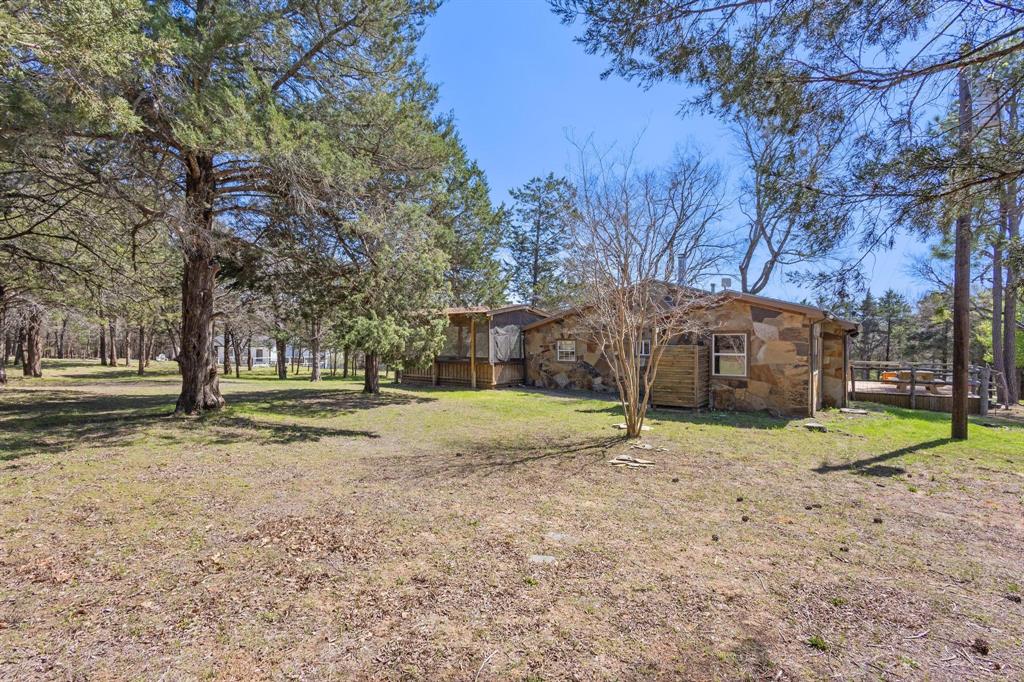 236 Homesite Road Pottsboro, TX 75076 - Photo 4 of 40 a house with trees in front of it