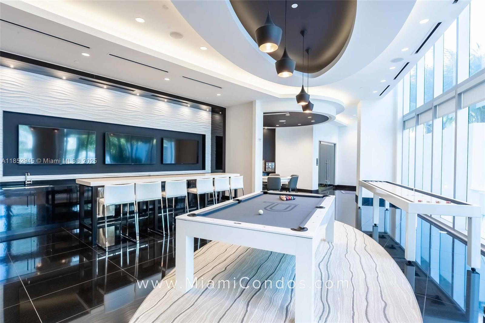 851 Northeast 1st Avenue, Unit 1010 Miami, FL 33132 - Photo 18 of 20 a very nice looking room with a large window and flat screen tv