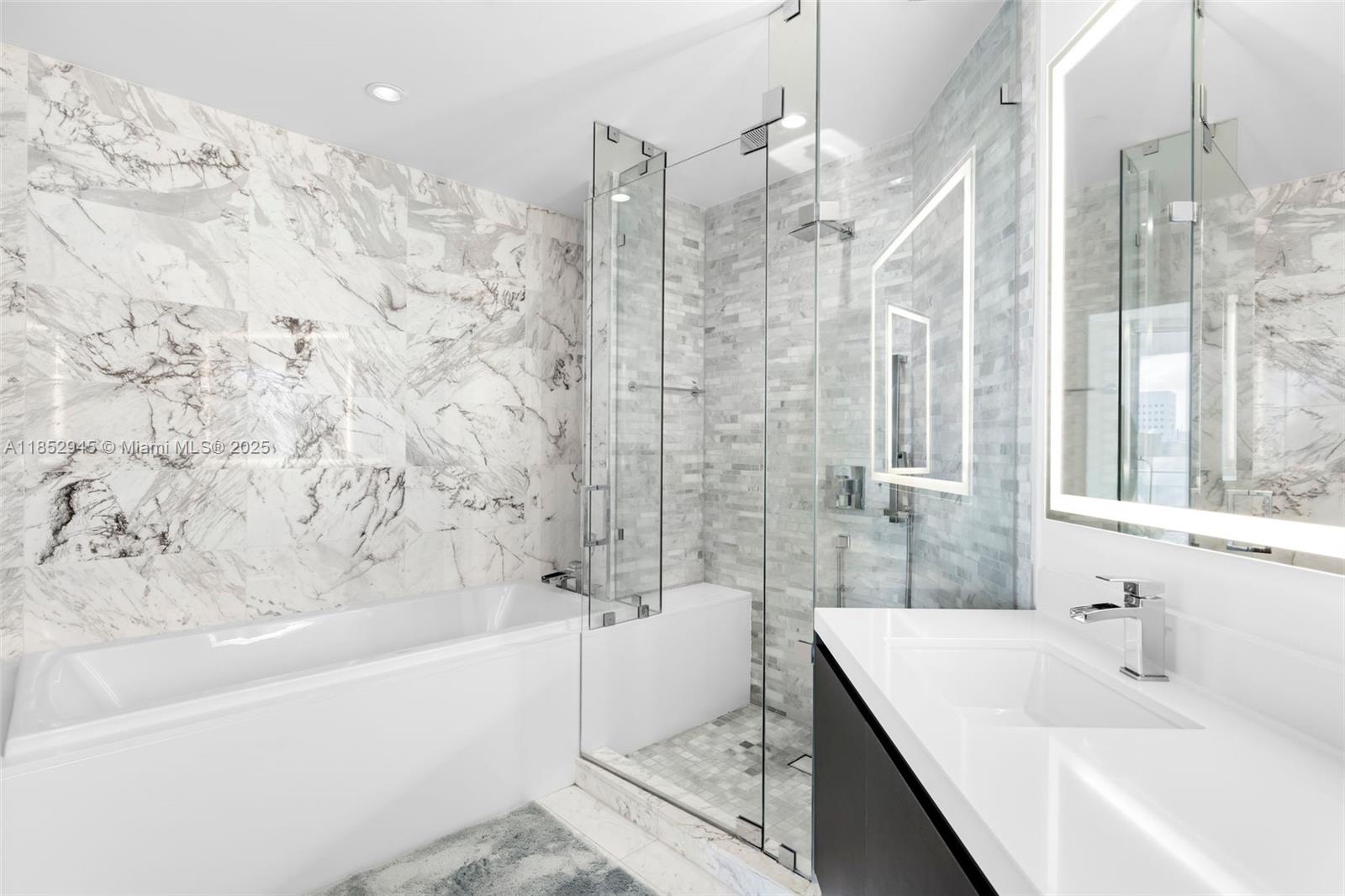 851 Northeast 1st Avenue, Unit 1010 Miami, FL 33132 - Photo 8 of 20 a bathroom with a bathtub and shower