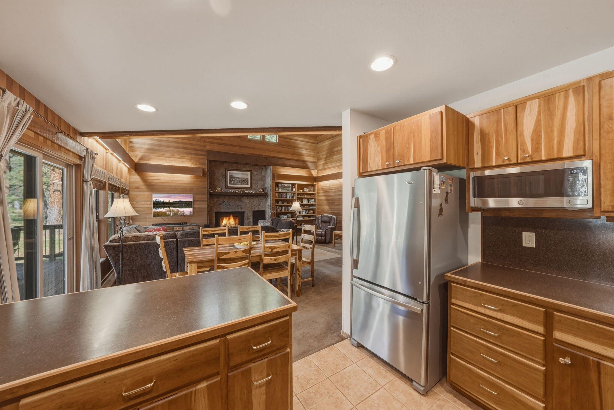 13137 Hawks Beard, Unit GH 129 Black Butte Ranch, OR 97759 - Photo 11 of 57 a kitchen with stainless steel appliances granite countertop a refrigerator a stove and a sink with wooden floors