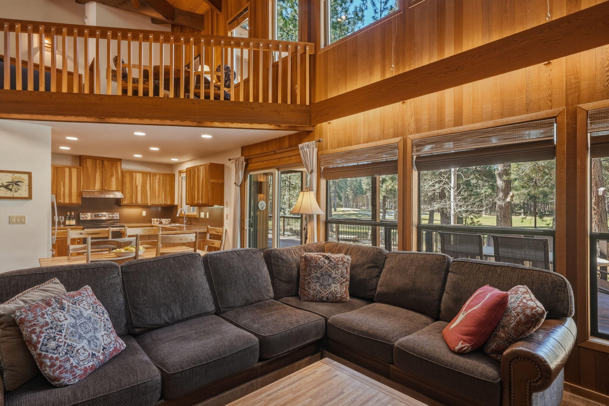 13137 Hawks Beard, Unit GH 129 Black Butte Ranch, OR 97759 - Photo 12 of 57 a living room with furniture a large window and a chandelier