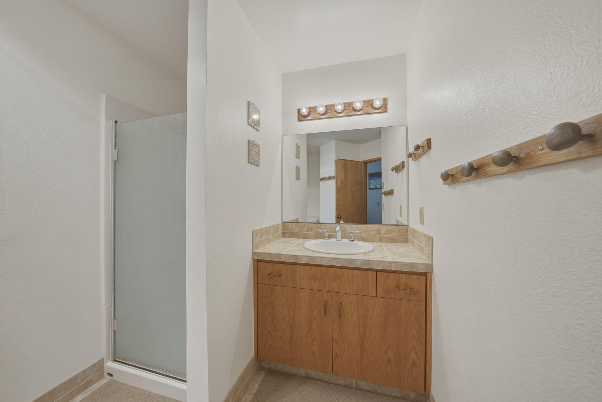 13137 Hawks Beard, Unit GH 129 Black Butte Ranch, OR 97759 - Photo 29 of 57 a bathroom with a granite countertop sink and a mirror