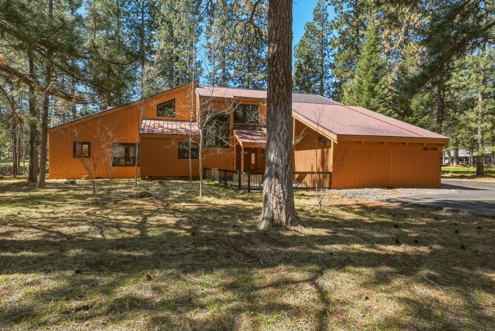 13137 Hawks Beard, Unit GH 129 Black Butte Ranch, OR 97759 - Photo 55 of 57 a backyard of a house with large trees and wooden fence