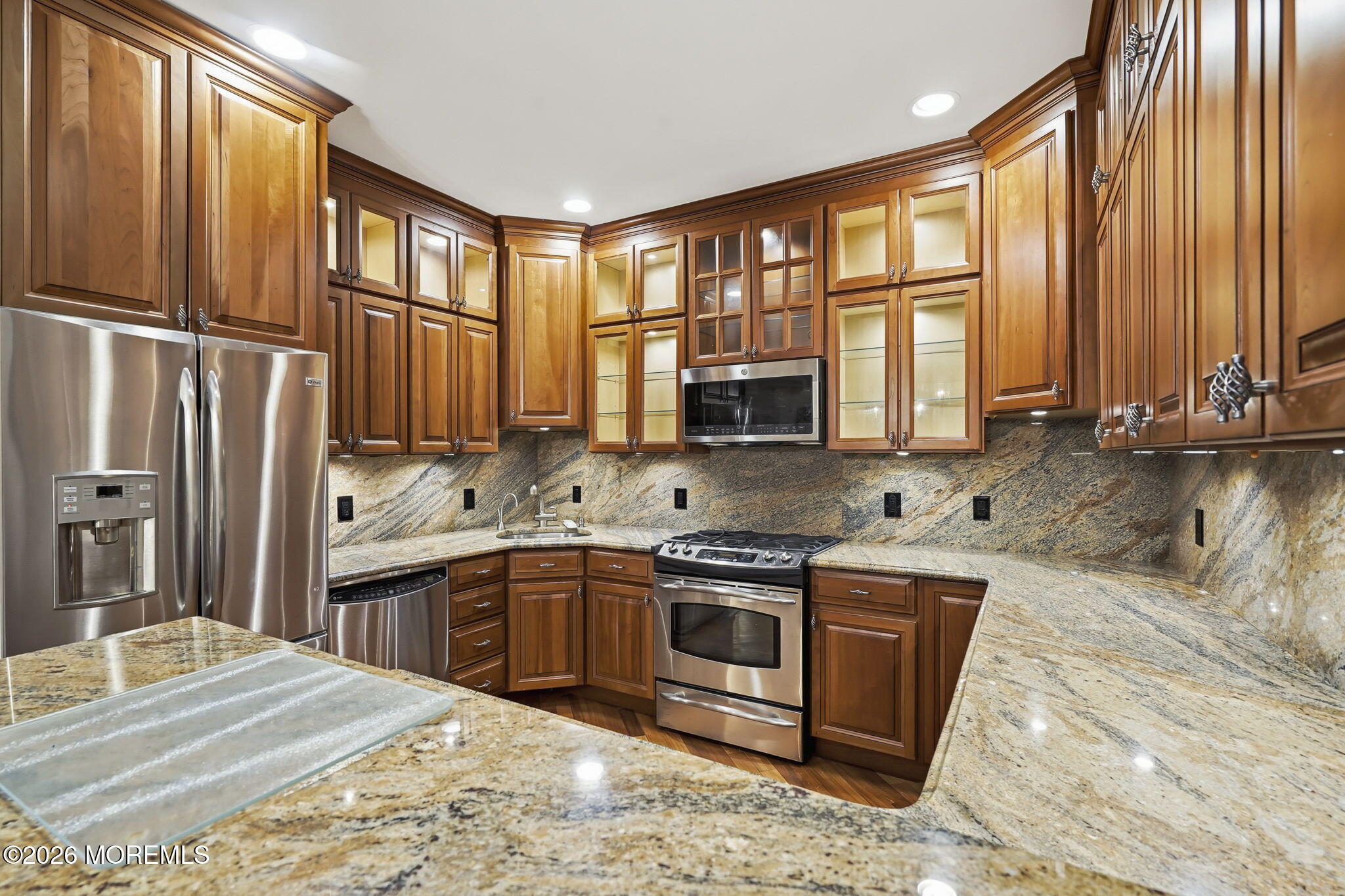 106 Potts Road Morganville, NJ 07751 - Photo 9 of 25 a kitchen with stainless steel appliances granite countertop a refrigerator sink and cabinets