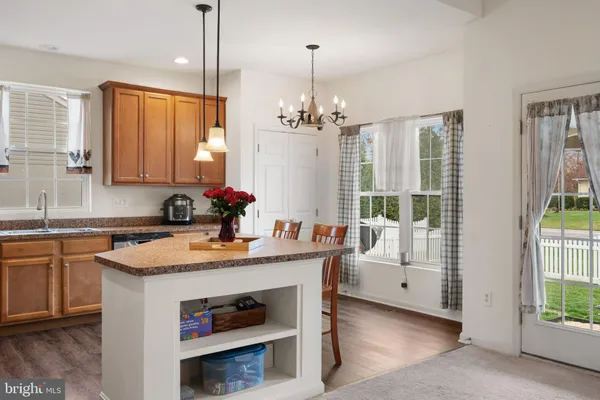 a kitchen that has a sink a stove and a wooden floor
